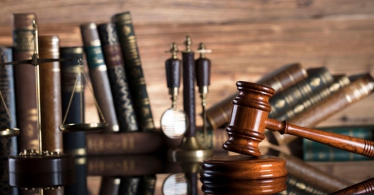 a gavel, a scale and law books